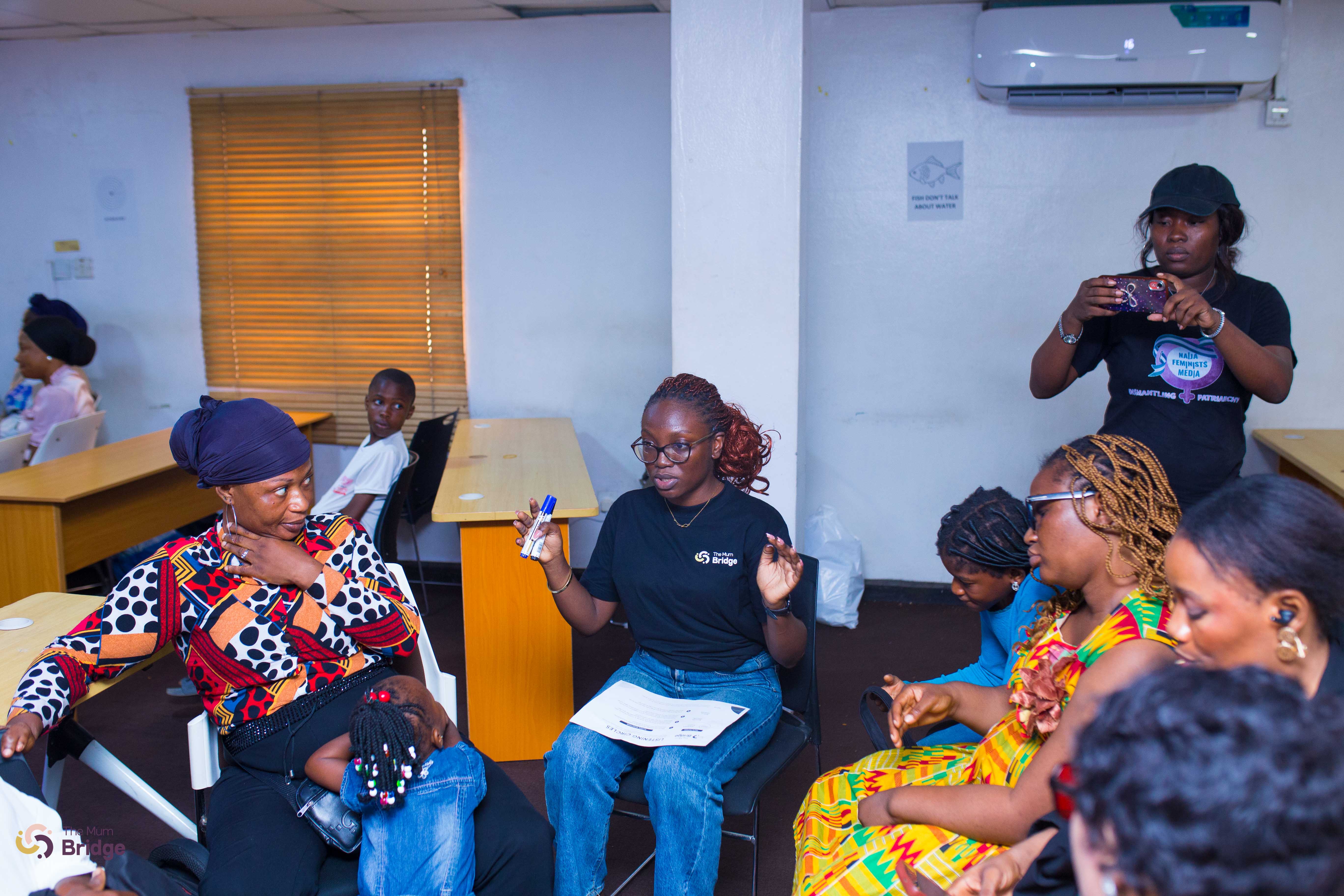A Mum Bridge team member facilitates a small group discussion, guiding participants in a breakout activity