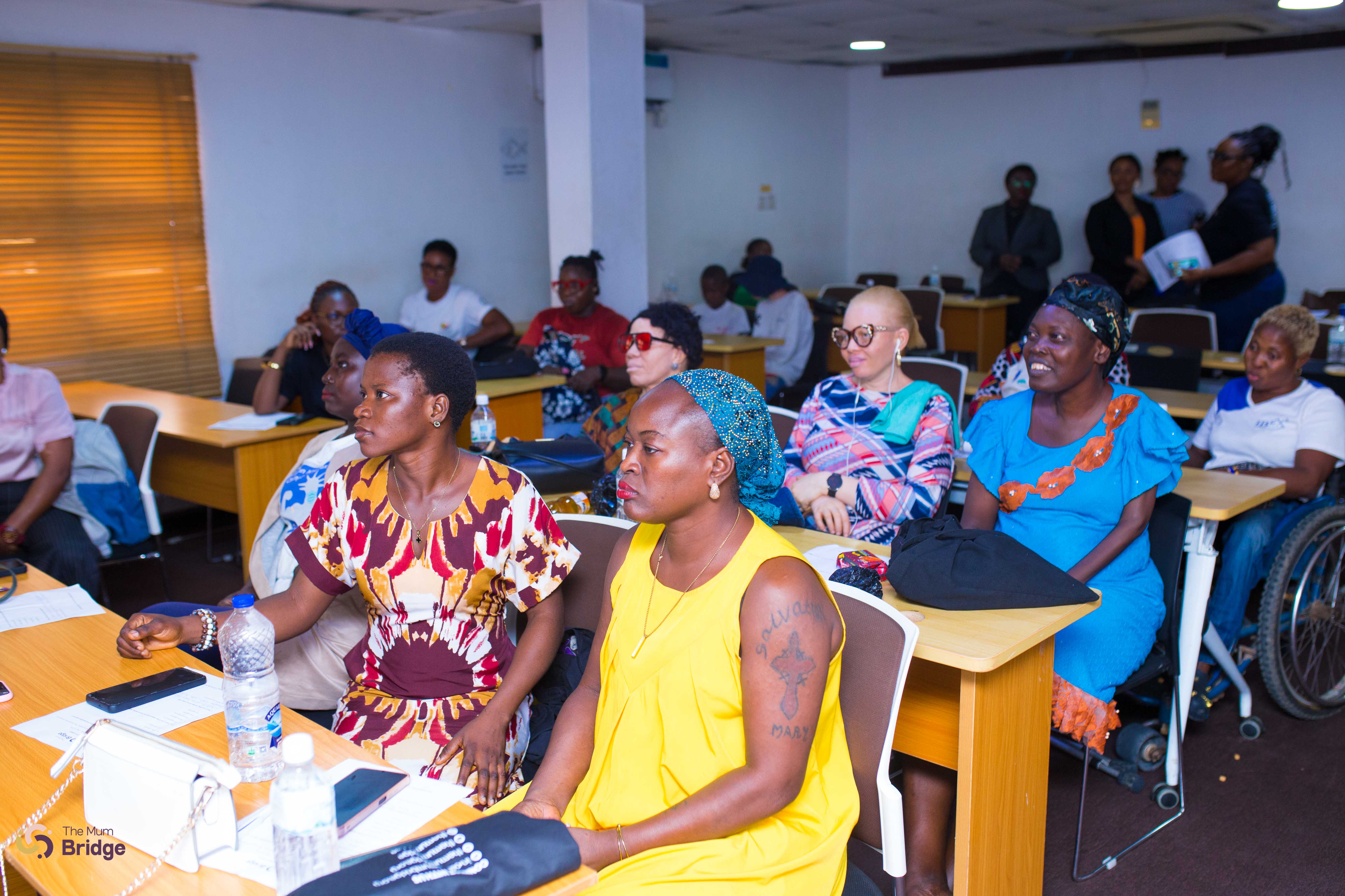 Mothers with disabilities seated together during a Mum Bridge community session, including a participant using a wheelchair