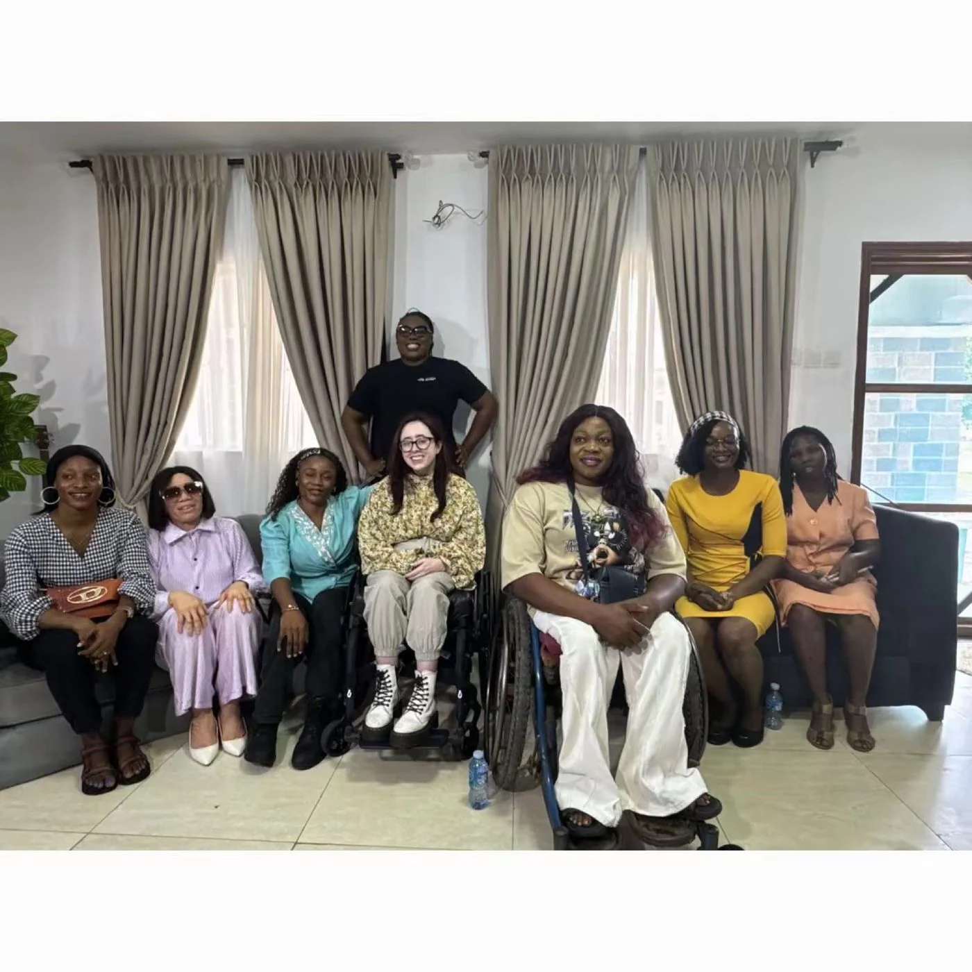 The Mum Bridge community gathered for the visit with disability advocate Niamh Ni Hoireabhaird, with mothers seated together and two participants using wheelchairs